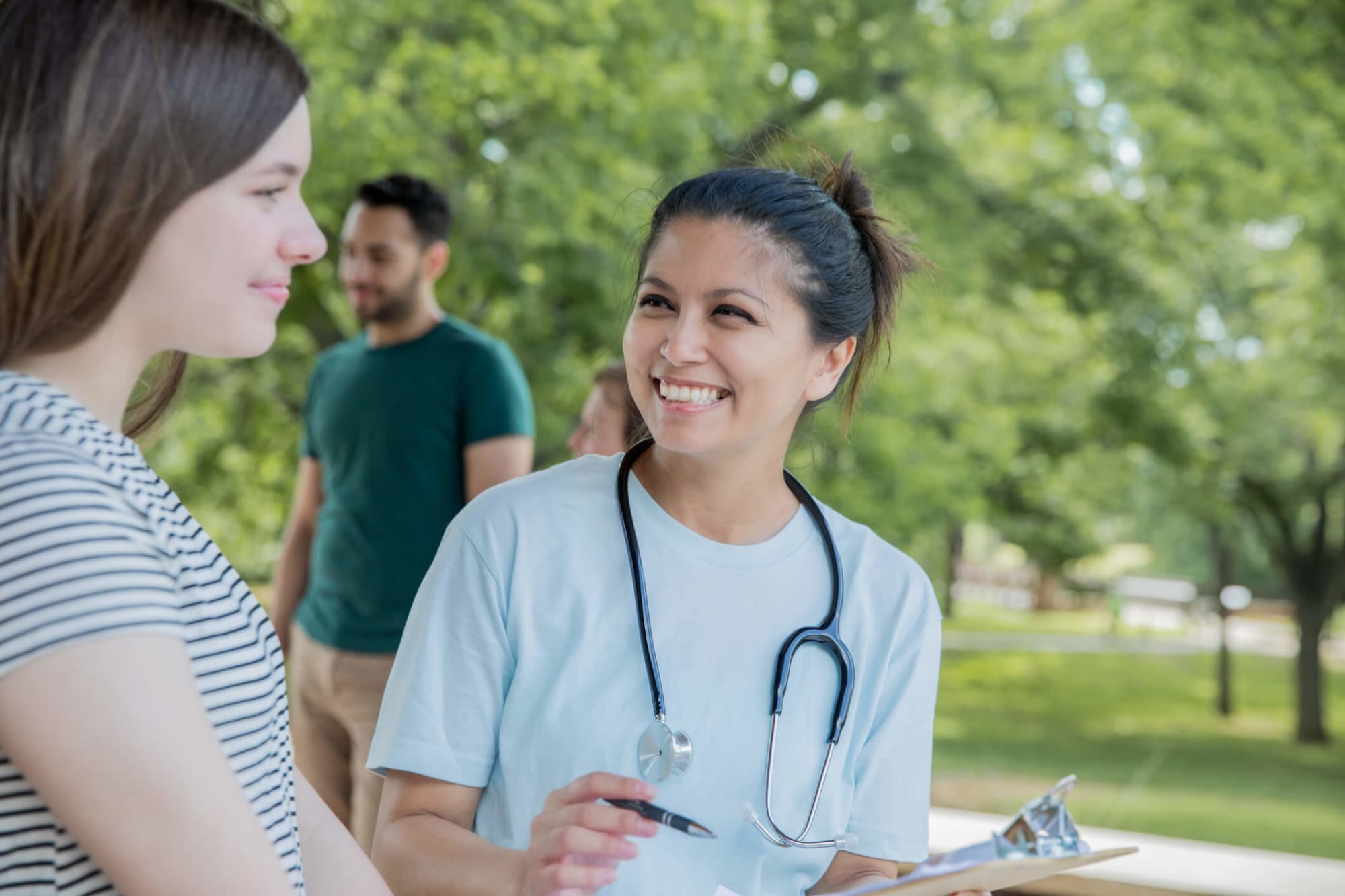 Community nurse outdoors with patient