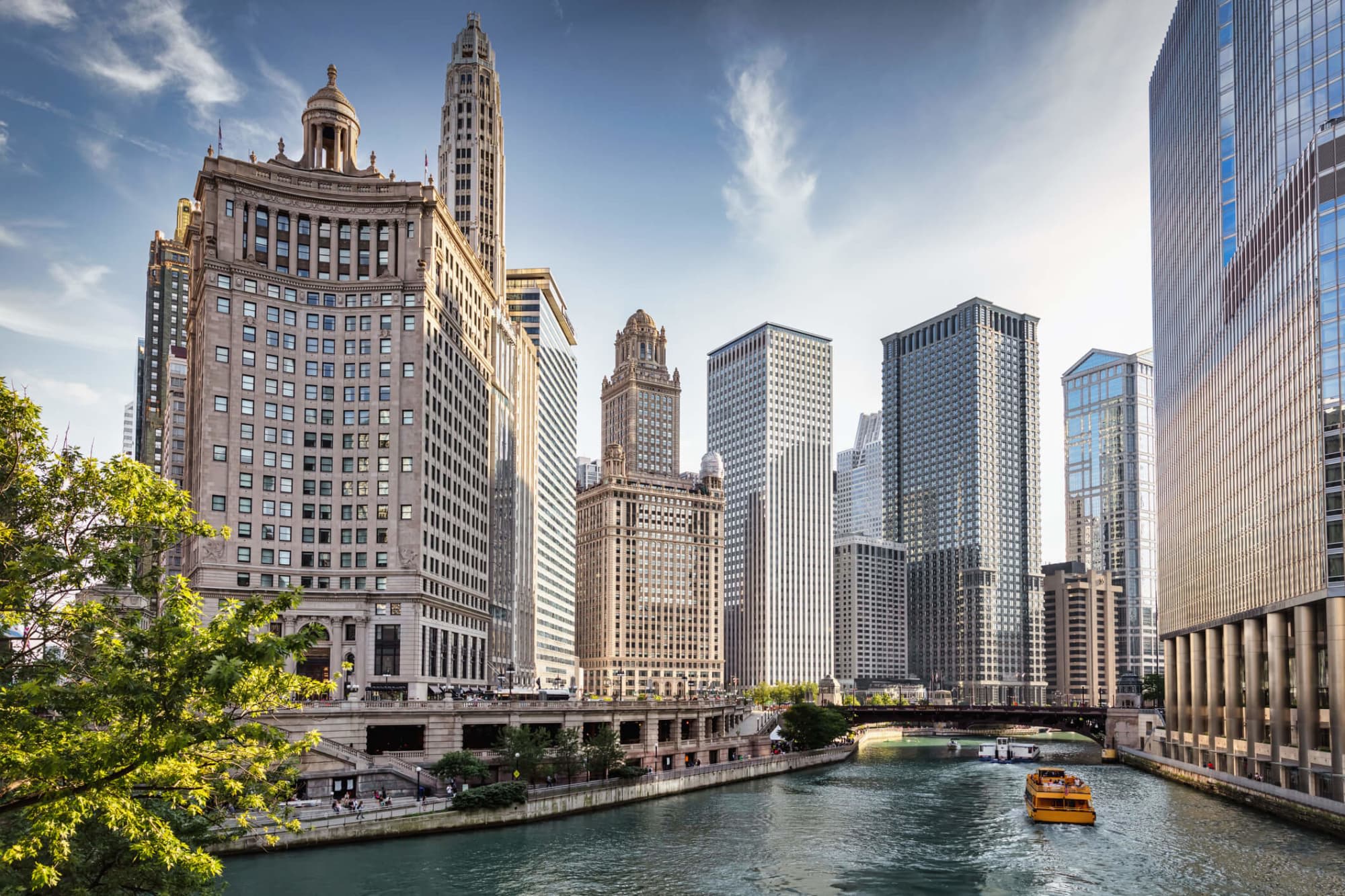 A city tour boat cruising on the Chicago River through downtown Chicago, Illinois.