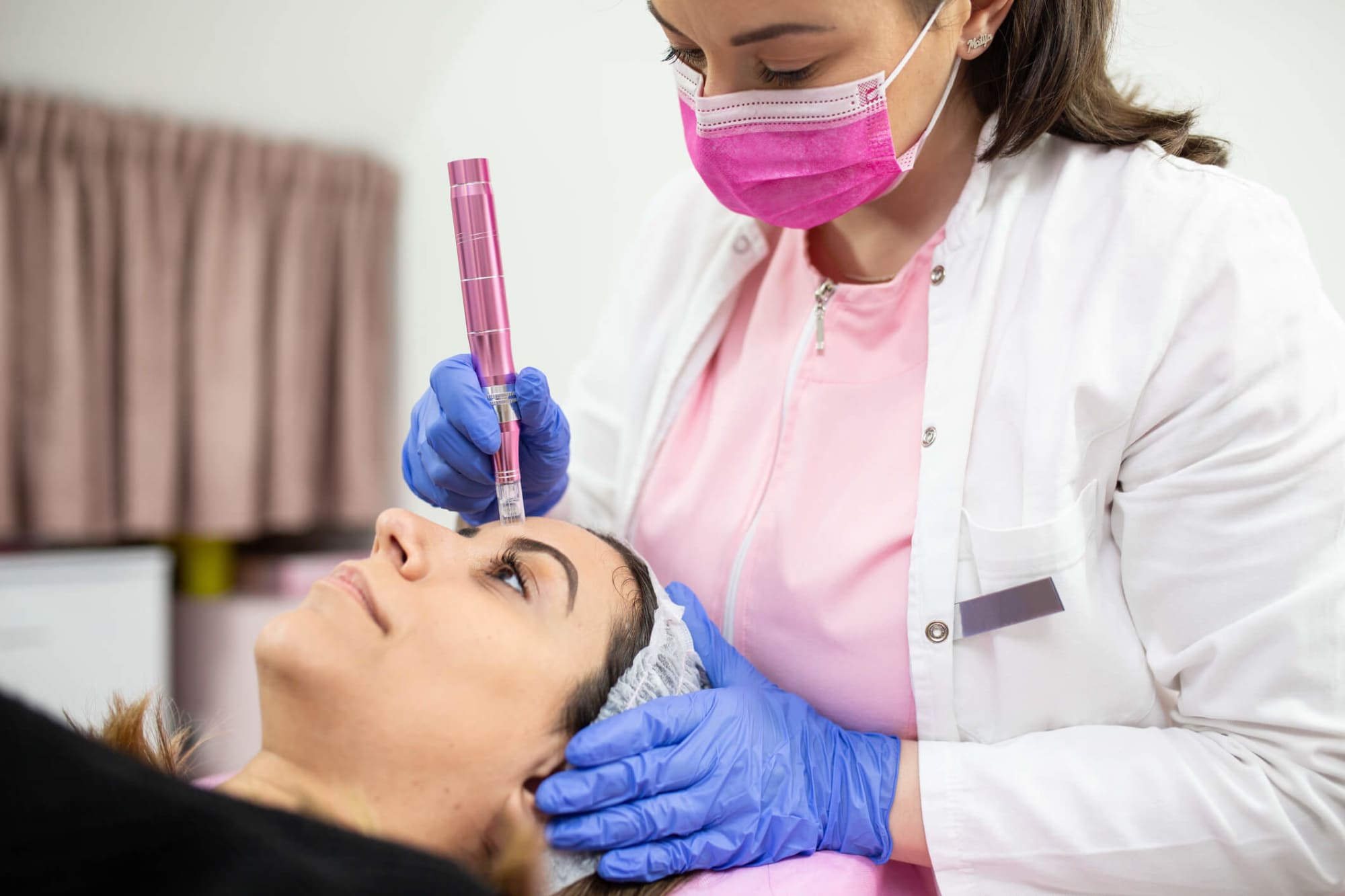 Plastic surgery nurse giving injection to patient