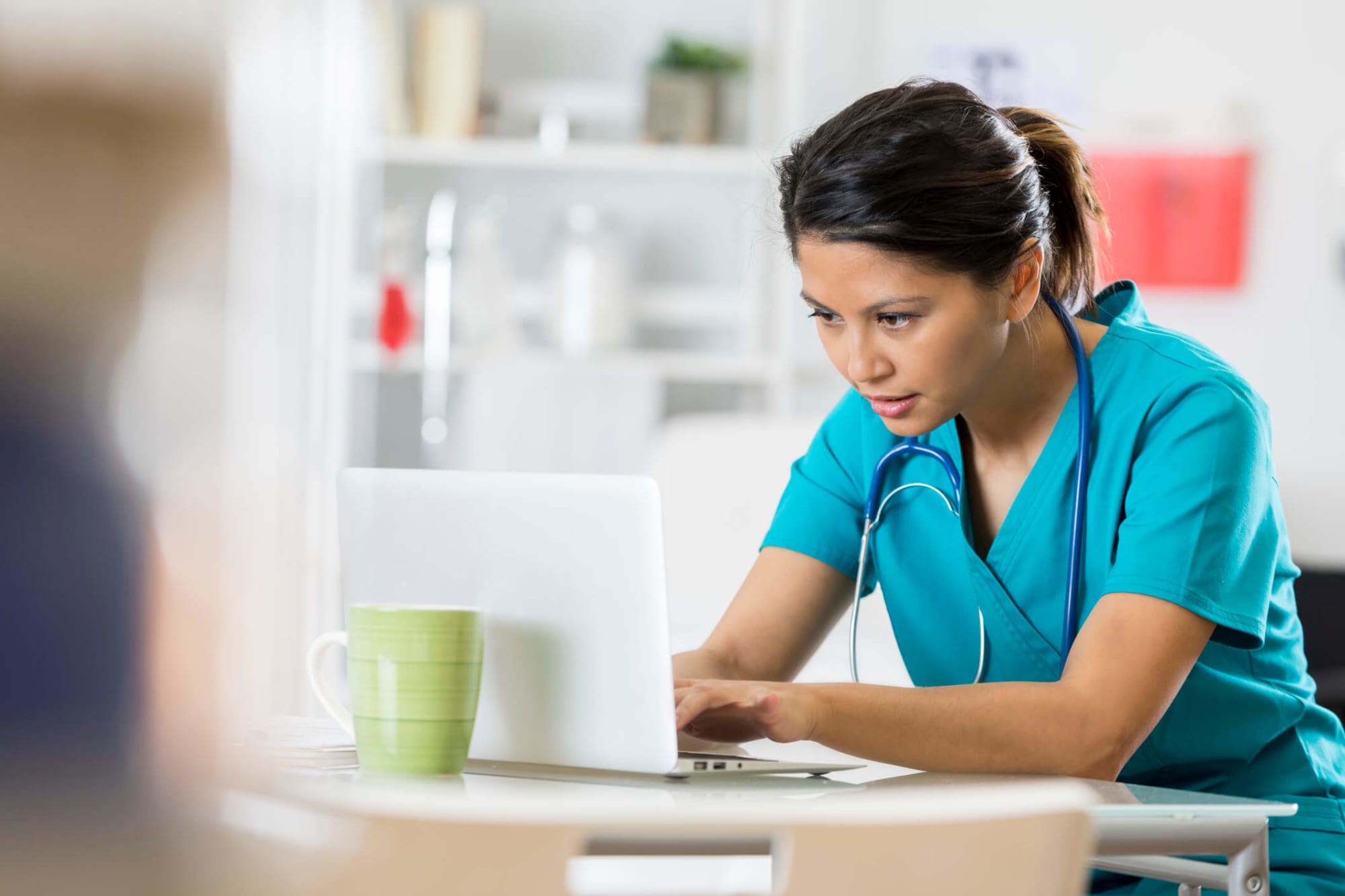 Female nursing student studying on laptop