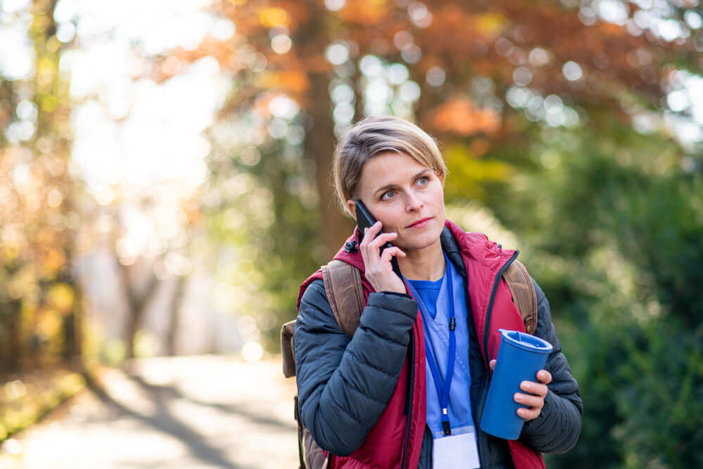 Female nursing student walking outdoors on her way to school. Image credit: Halfpoint / Shutterstock