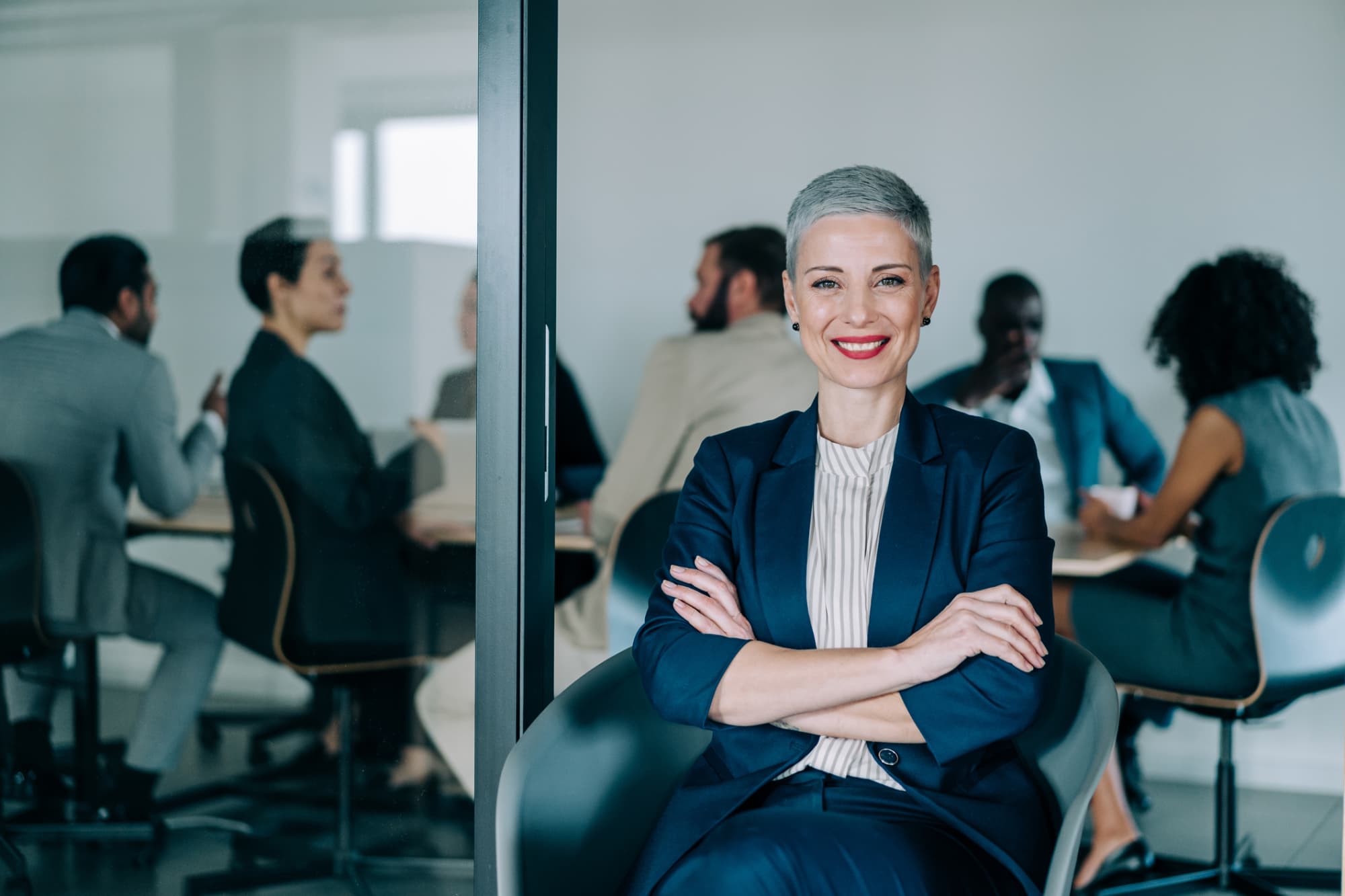 Businesswoman smiling confidently outside of a conference room