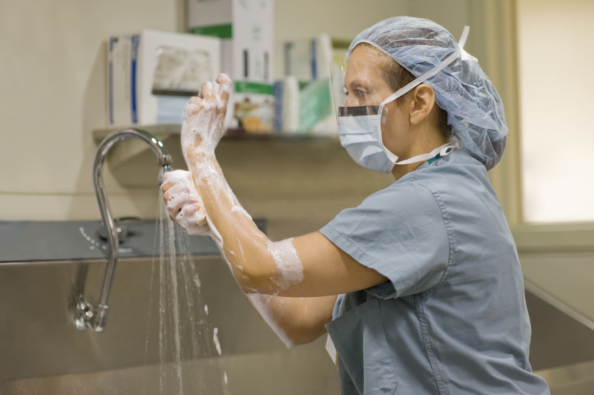 Surgical nurse scrubbing hands