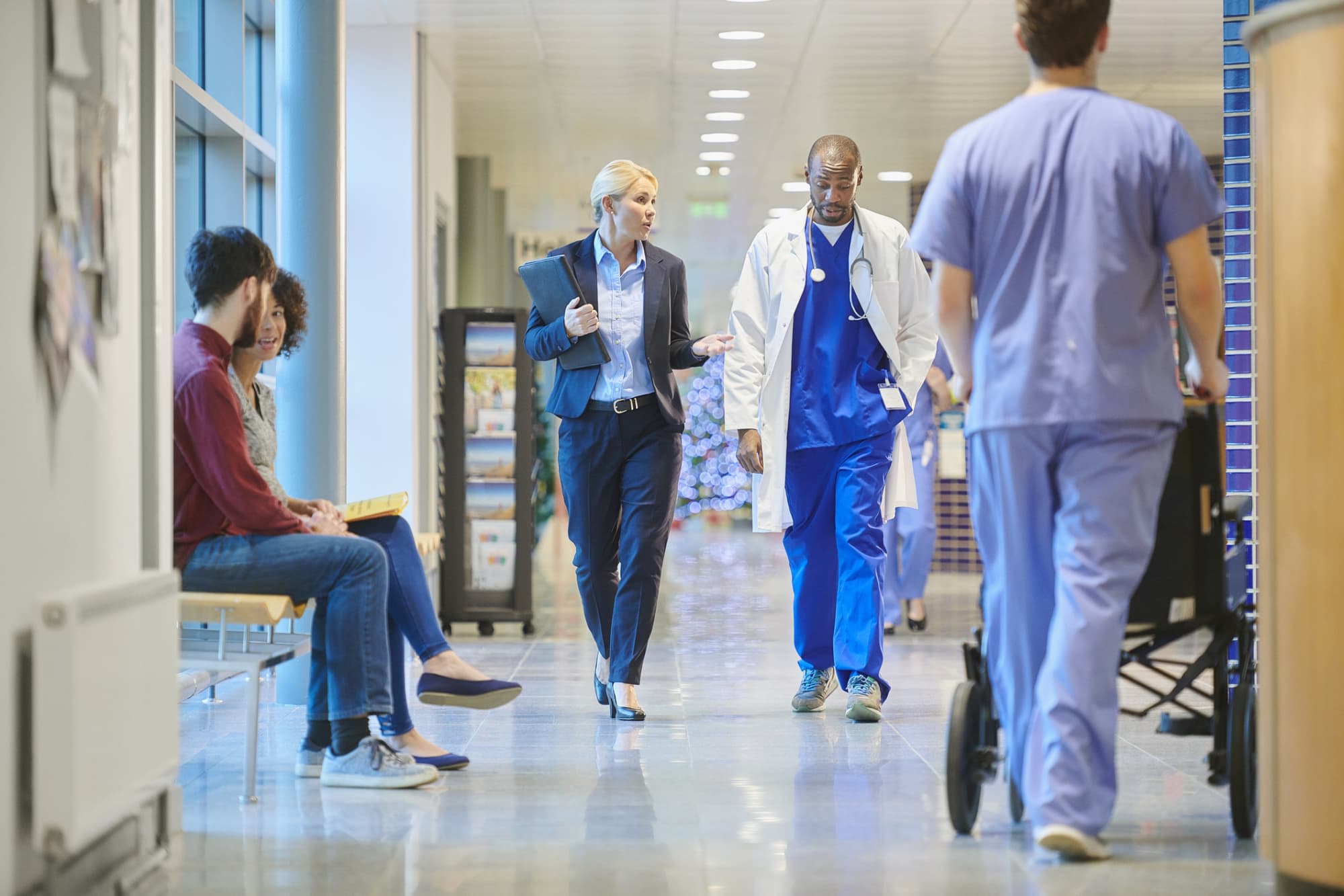 CNO talking to nurse in hospital hallway