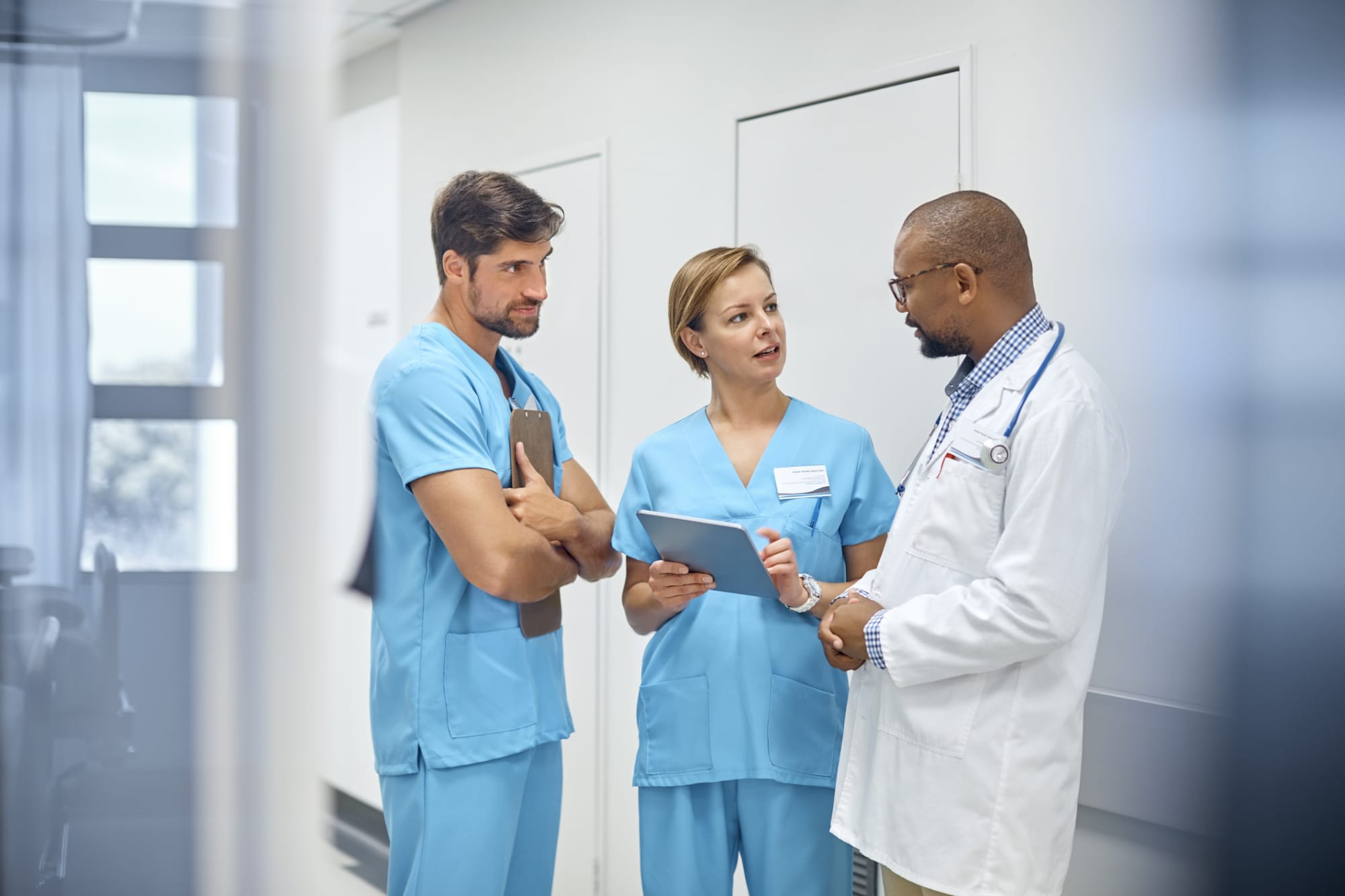 Nurses talking to a doctor about a patient's care