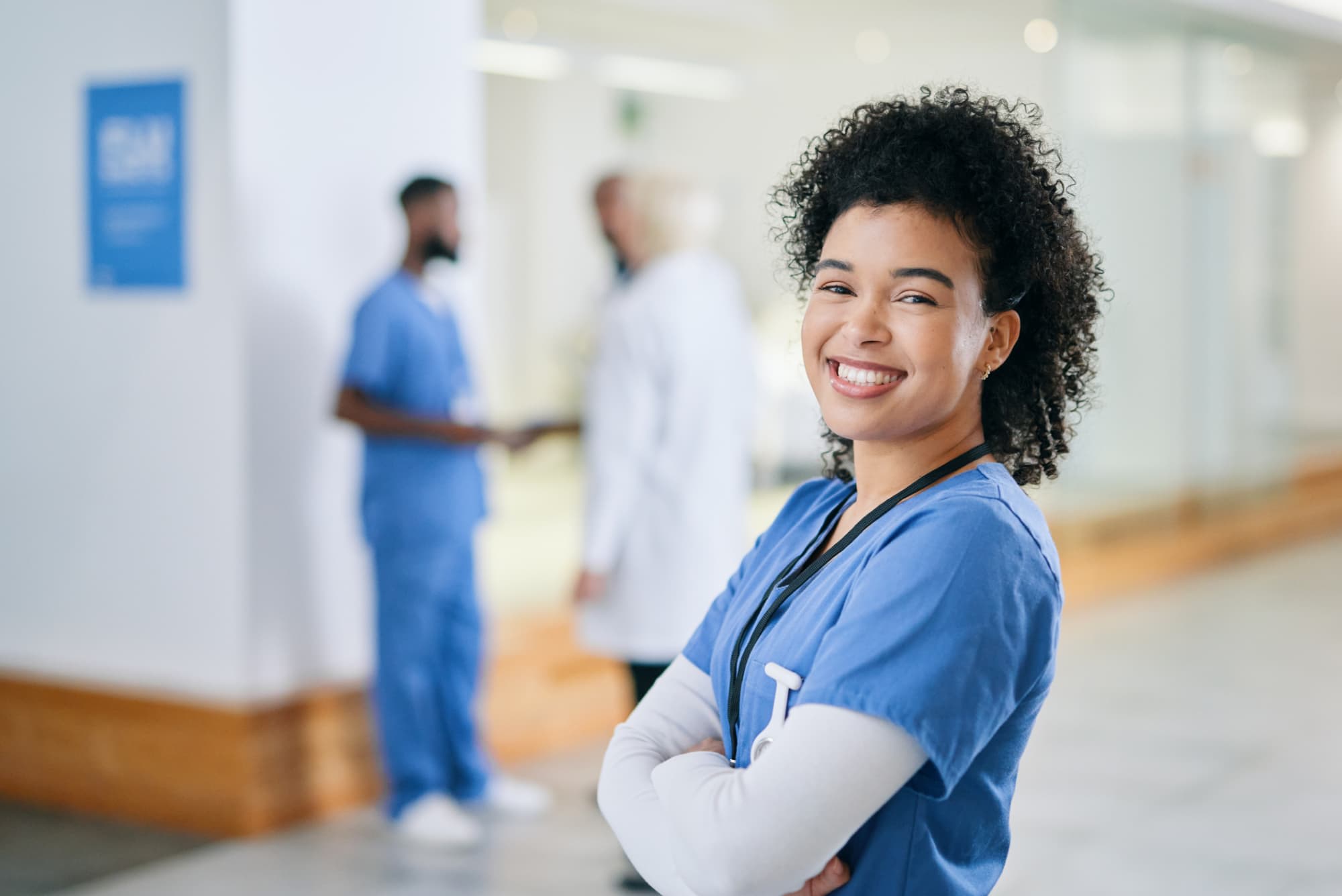 Nurse smiling in hospital hallway