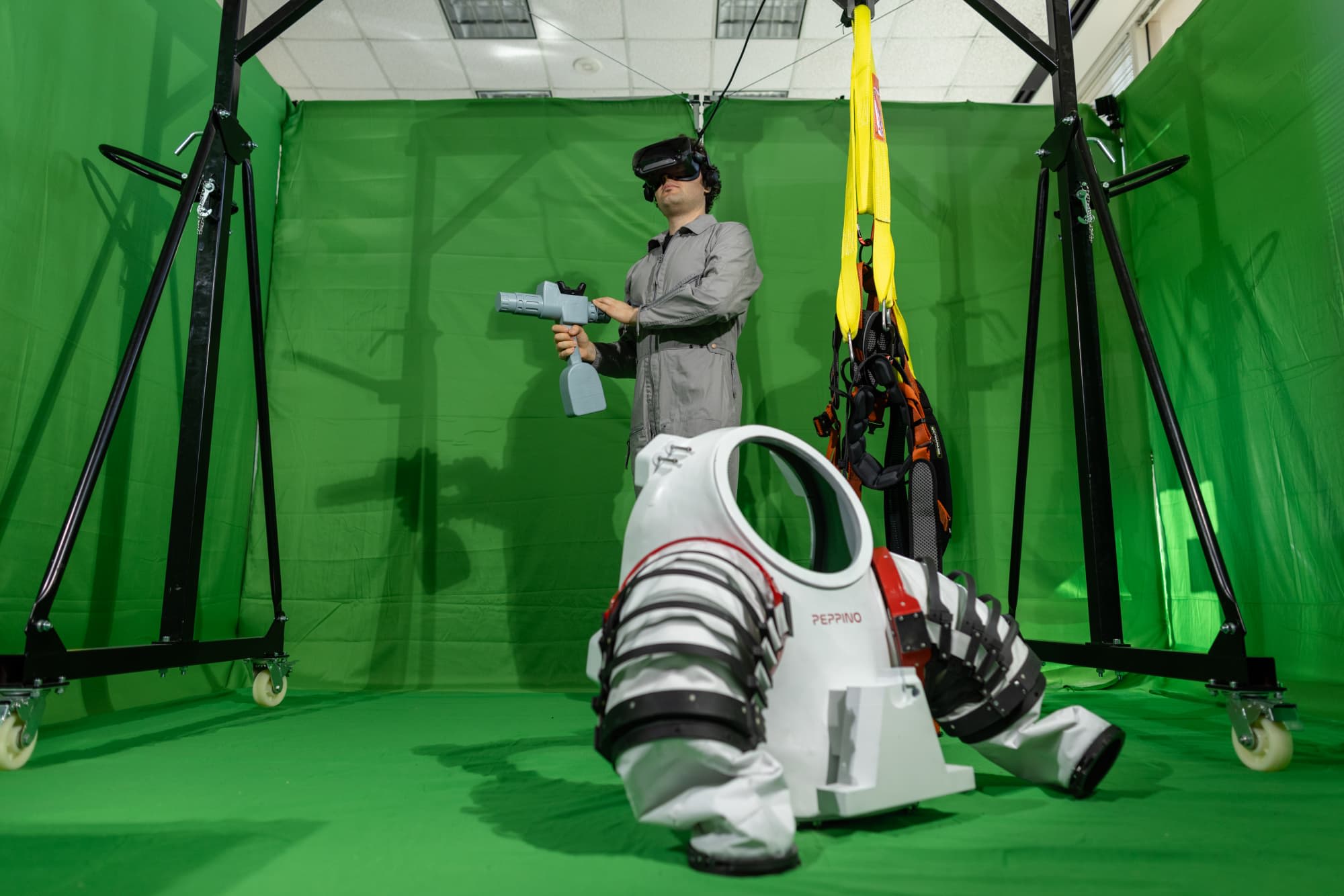 Paolo Mangili standing beside space suit in mixed reality lab