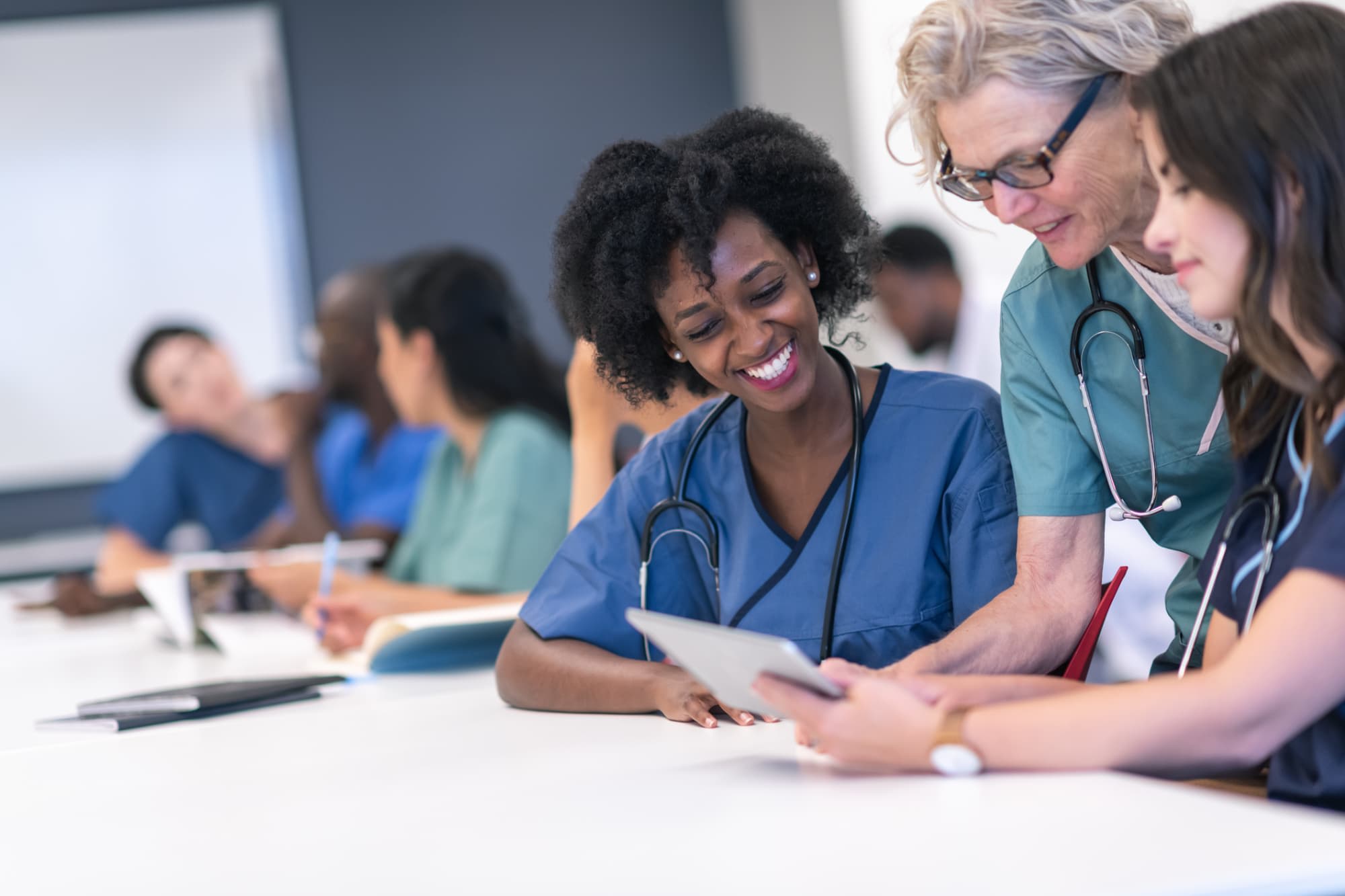 Older nurse mentoring younger nurses