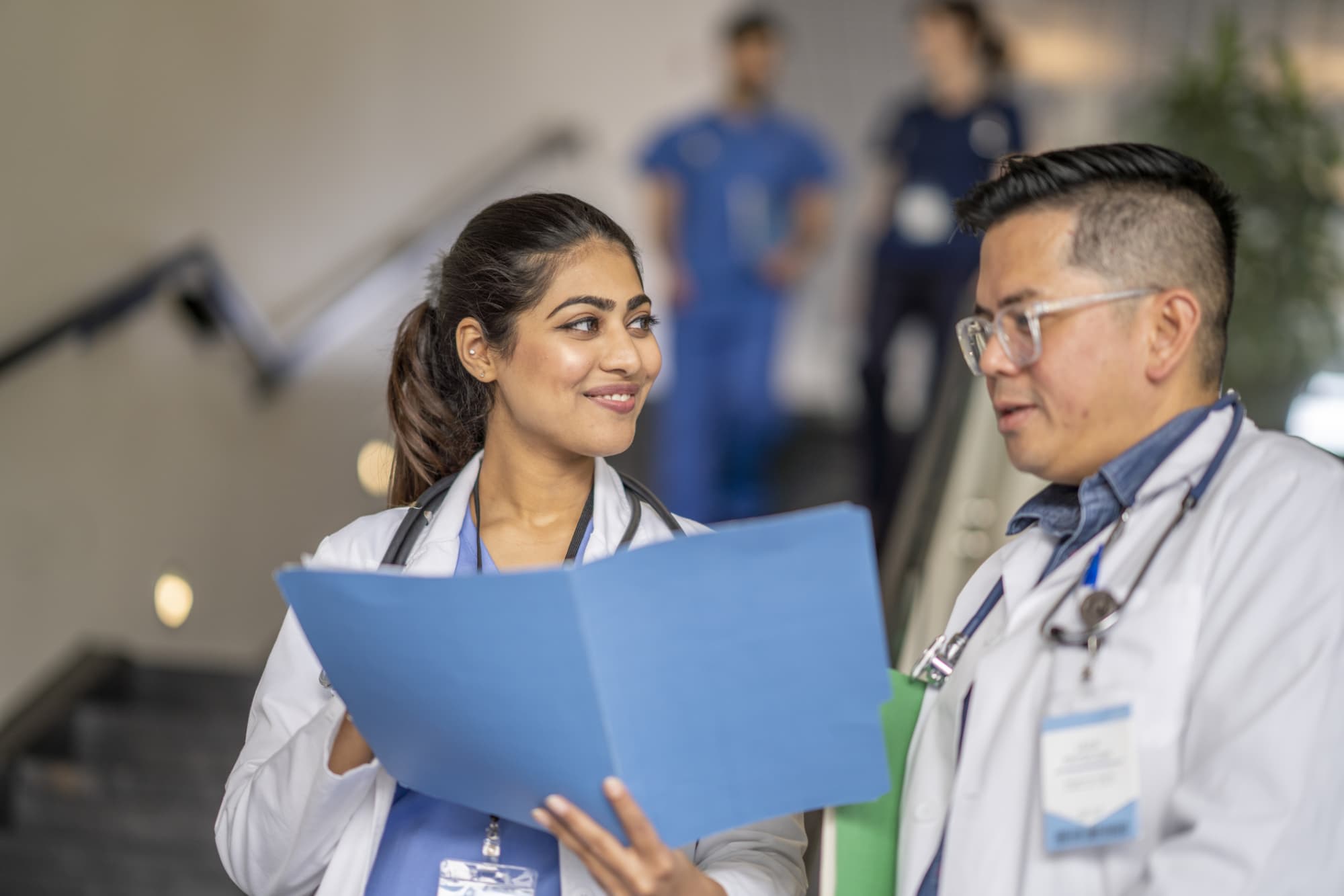 Nurses looking at a resume in a folder