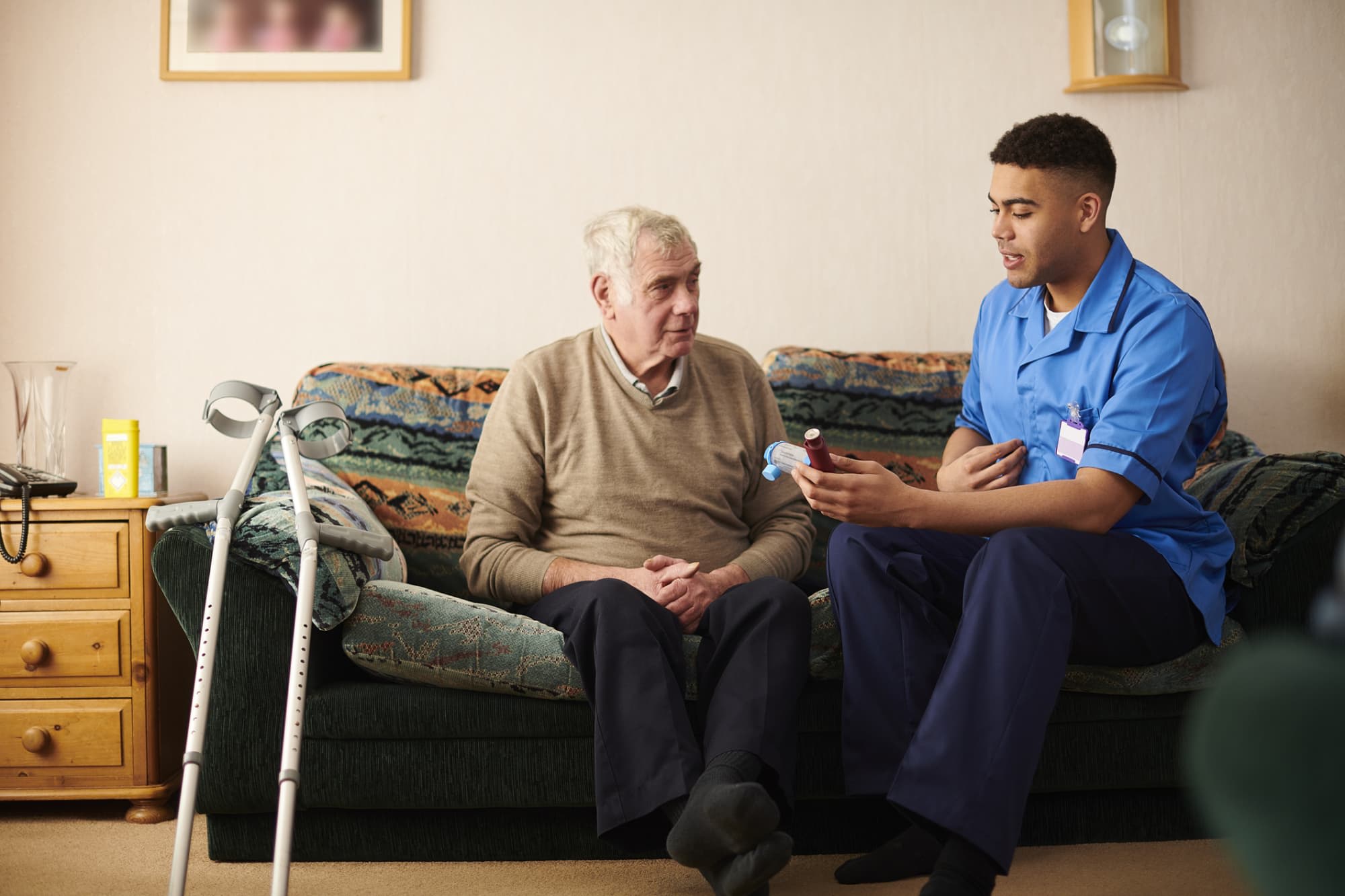 Nurse helping a patient at home