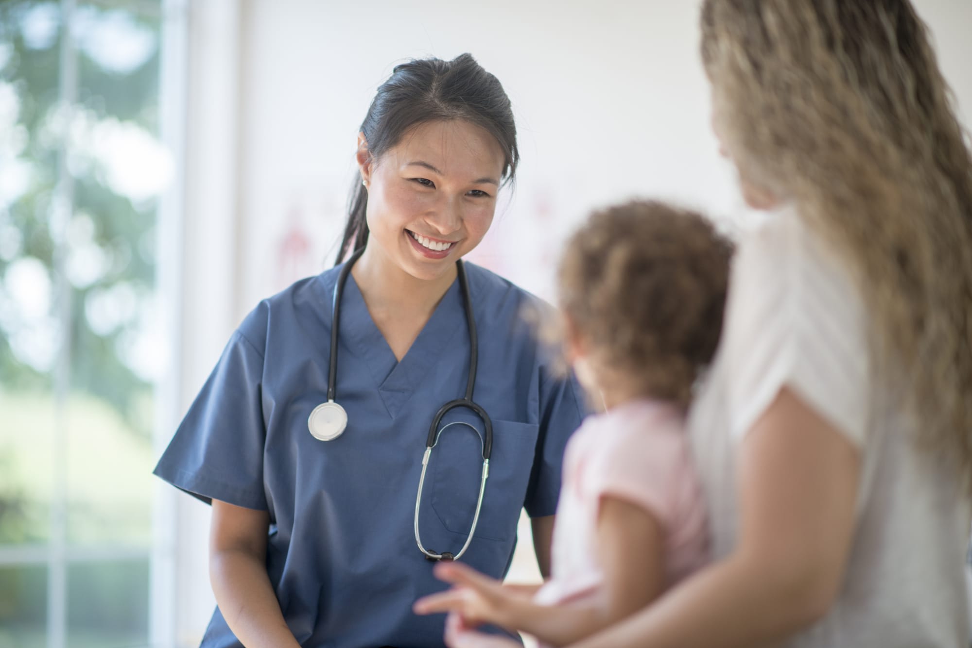 Nurse caring for a foster child and smiling