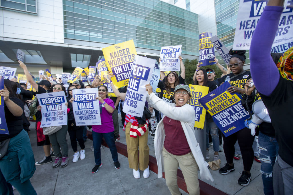 Kaiser Permanente healthcare workers holding signs on picket line