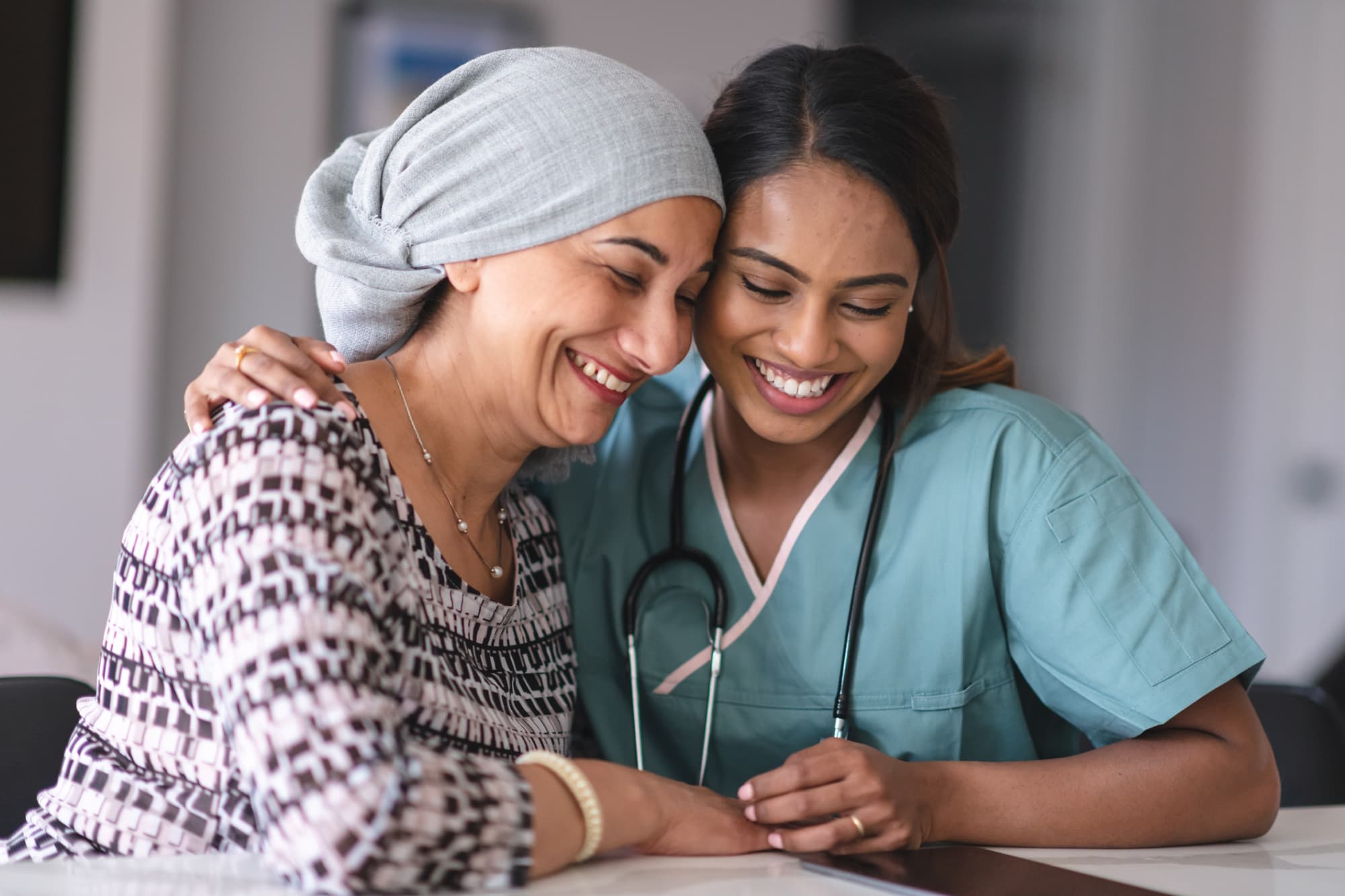 Oncology nurse hugging patient