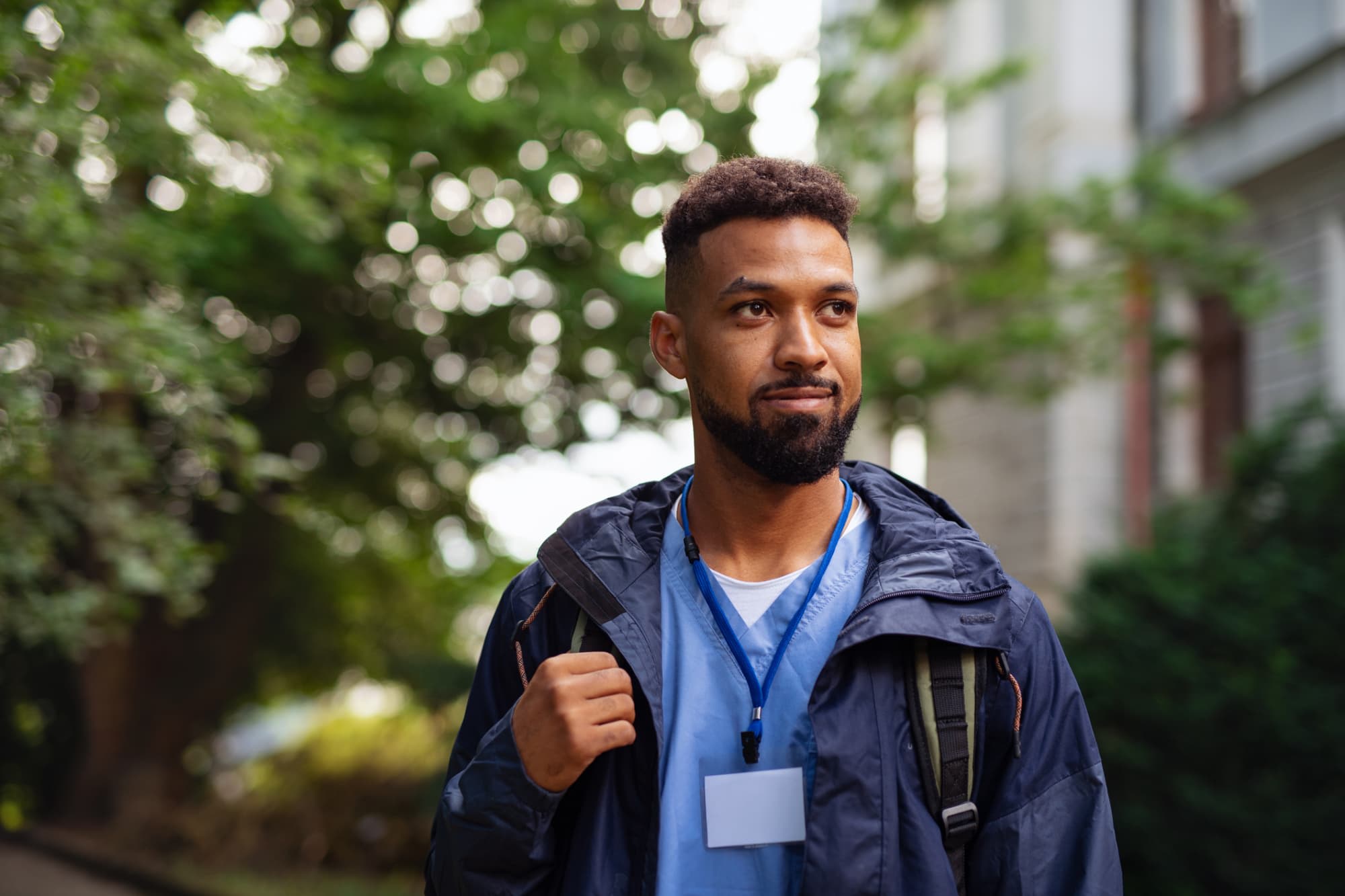 Male travel nurse walking outside