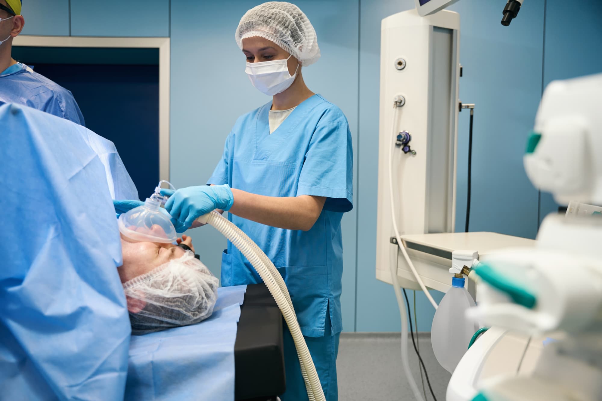 Nurse anesthetist helping patient in surgery