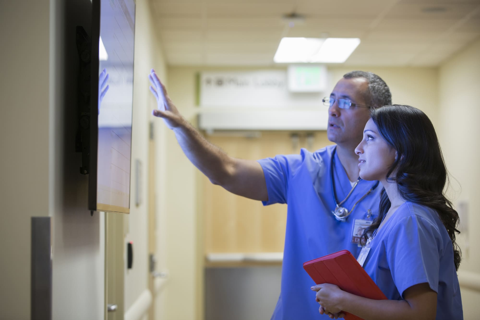 Nurses looking at staffing schedule board