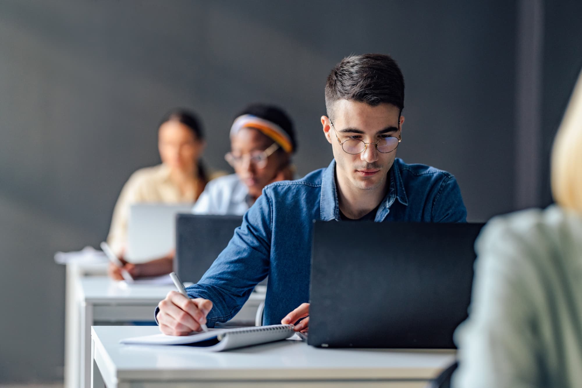 Students taking an entrance exam on laptops
