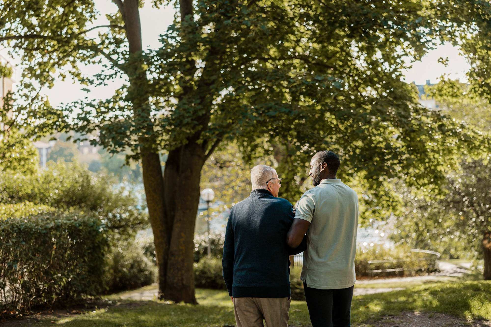 Mental healthcare worker assisting senior man outside