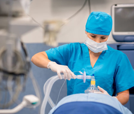 Nurse administering anesthesia to a patient