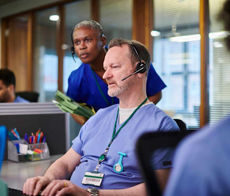 Healthcare professionals on computers in office