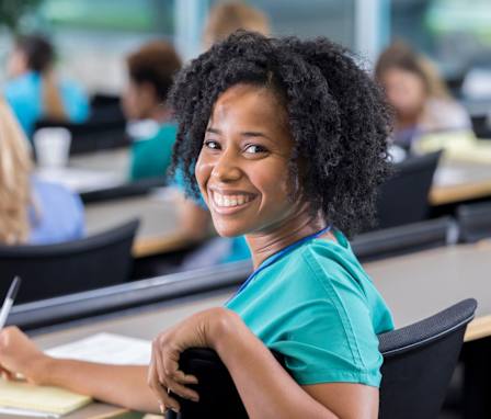 Nursing student takes notes in class