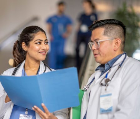 Nurses looking at a resume in a folder