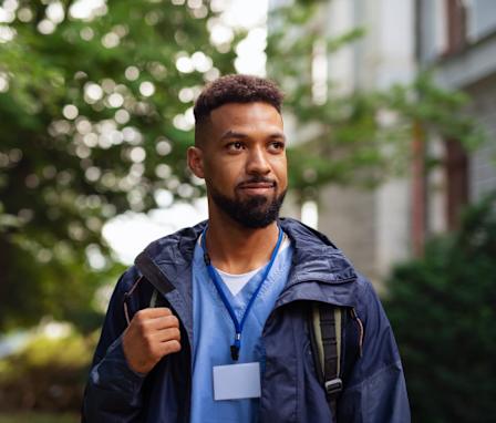 Male travel nurse walking outside