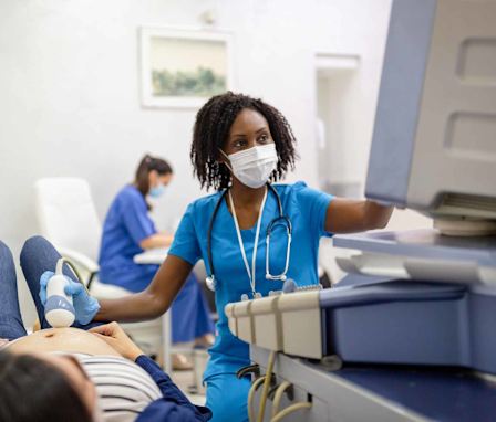 Nurse performing ultrasound on patient.