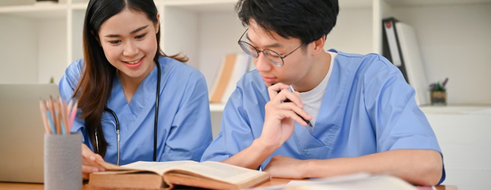 Nursing students studying together in the library