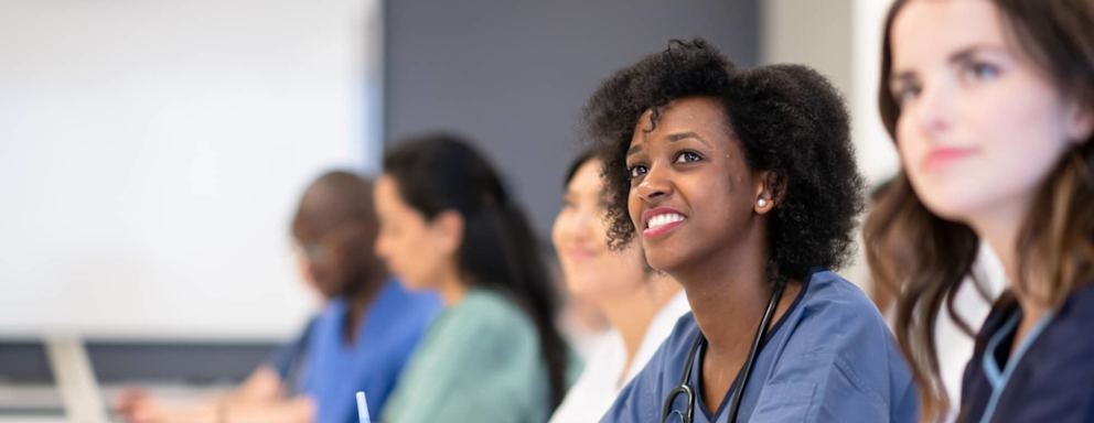 Nursing students taking notes in class