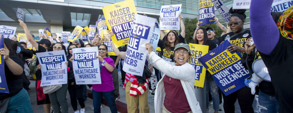Kaiser Permanente healthcare workers holding signs on picket line