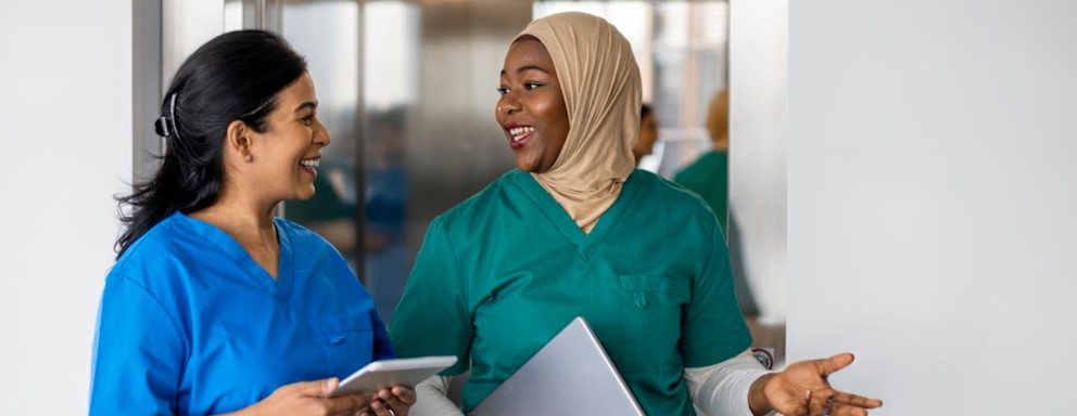 Nurses talking while getting off hospital elevator