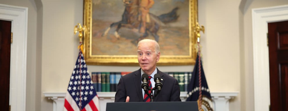 President Biden speaking at podium in White House about student loan forgiveness