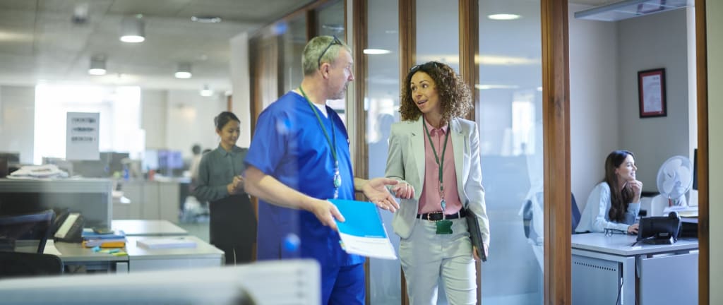 Healthcare professionals meeting and talking in an office