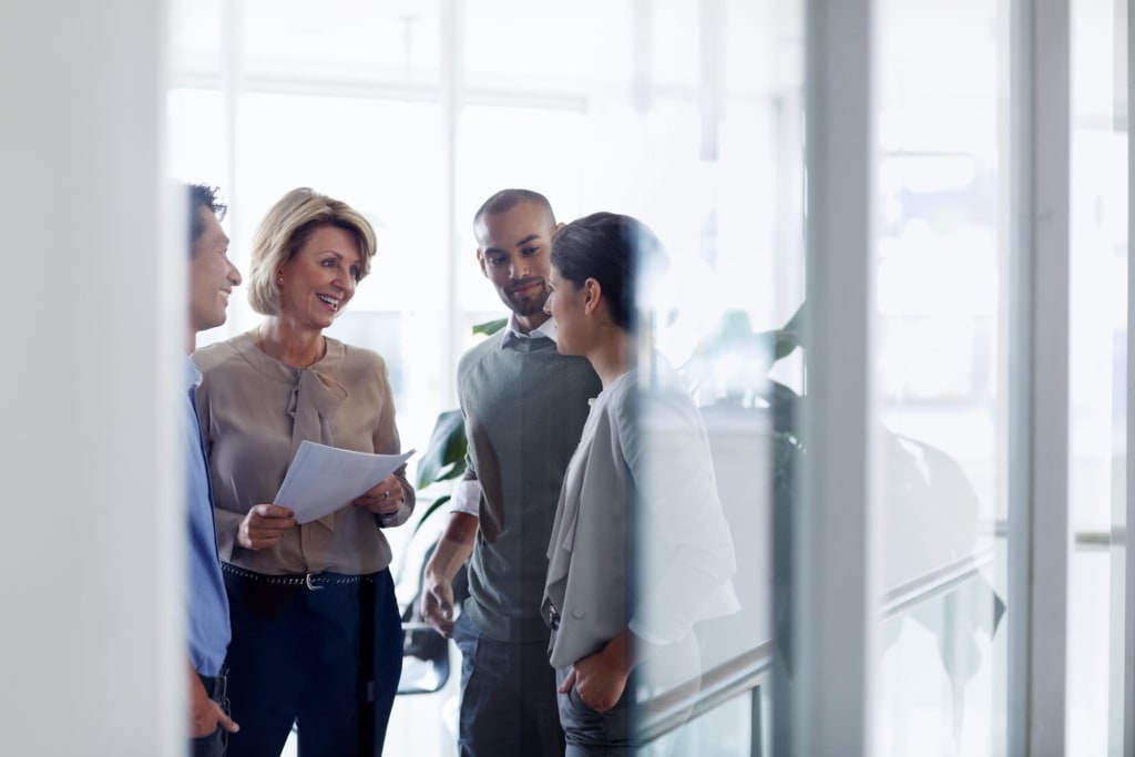 Business colleagues standing and talking together