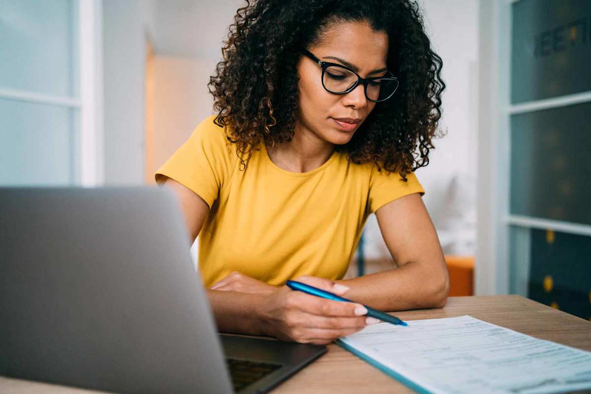 An online student works on her laptop at home.