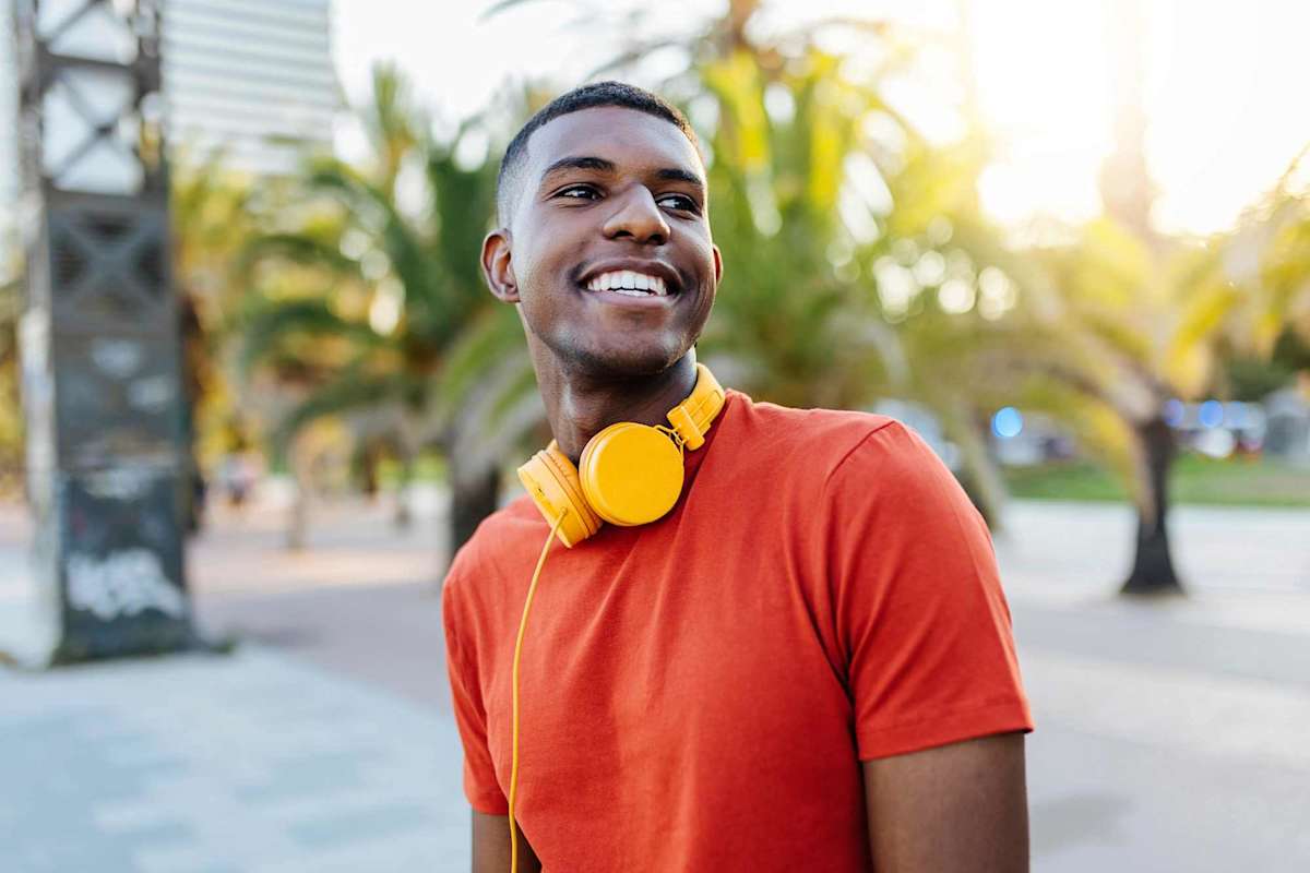 Music student smiling, wearing yellow headphones