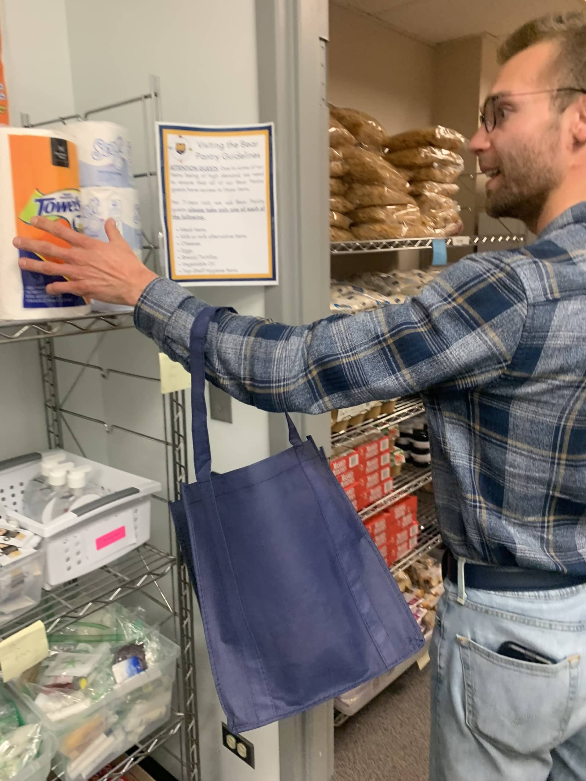 A student looking through a food pantry.