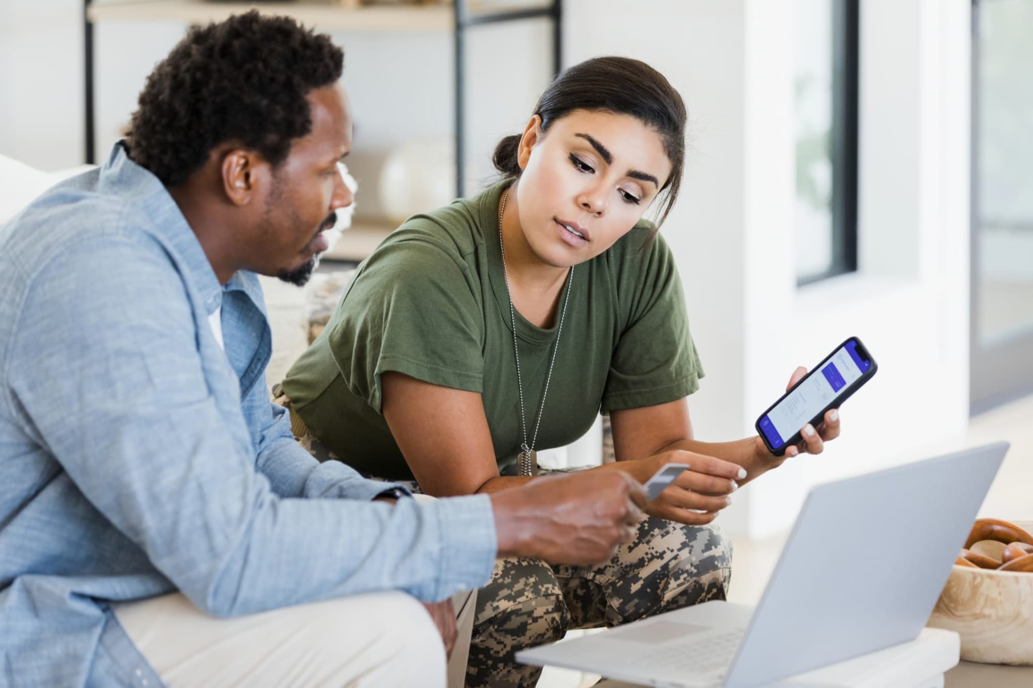 Veteran woman and man looking at laptop together