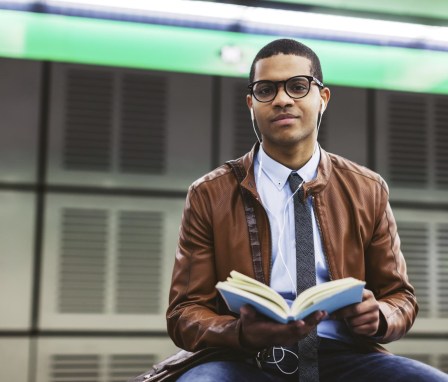 College student holding a book