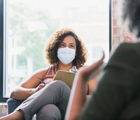 Female counselor wears mask during session