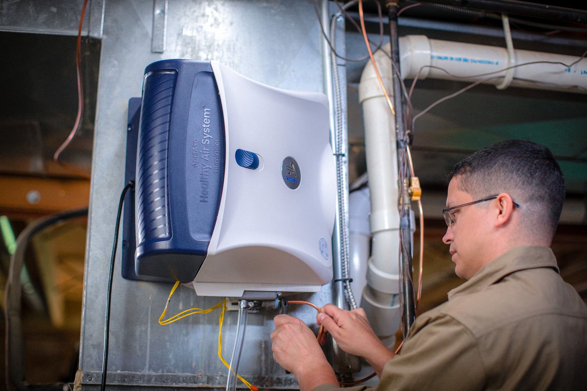 Bryant technician talking with homeowner while checking air filter and furnace