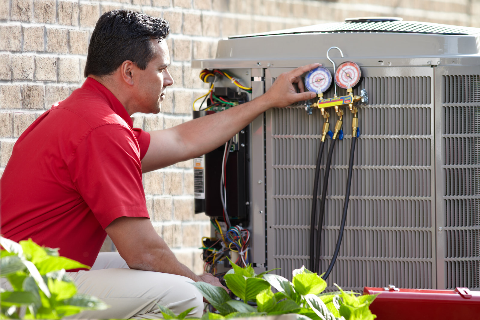 Bryant technician talking with homeowner while checking air filter and furnace