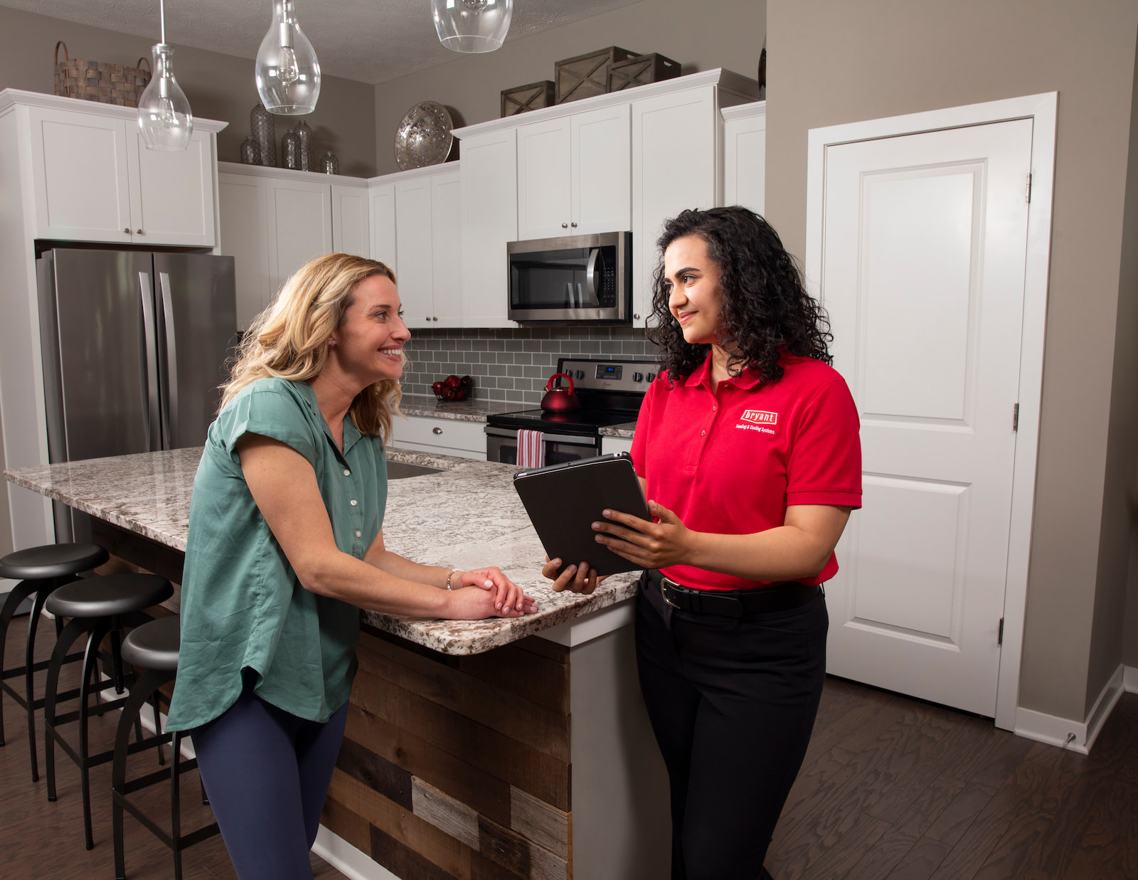 Bryant salesperson meeting with homeowners at kitchen table