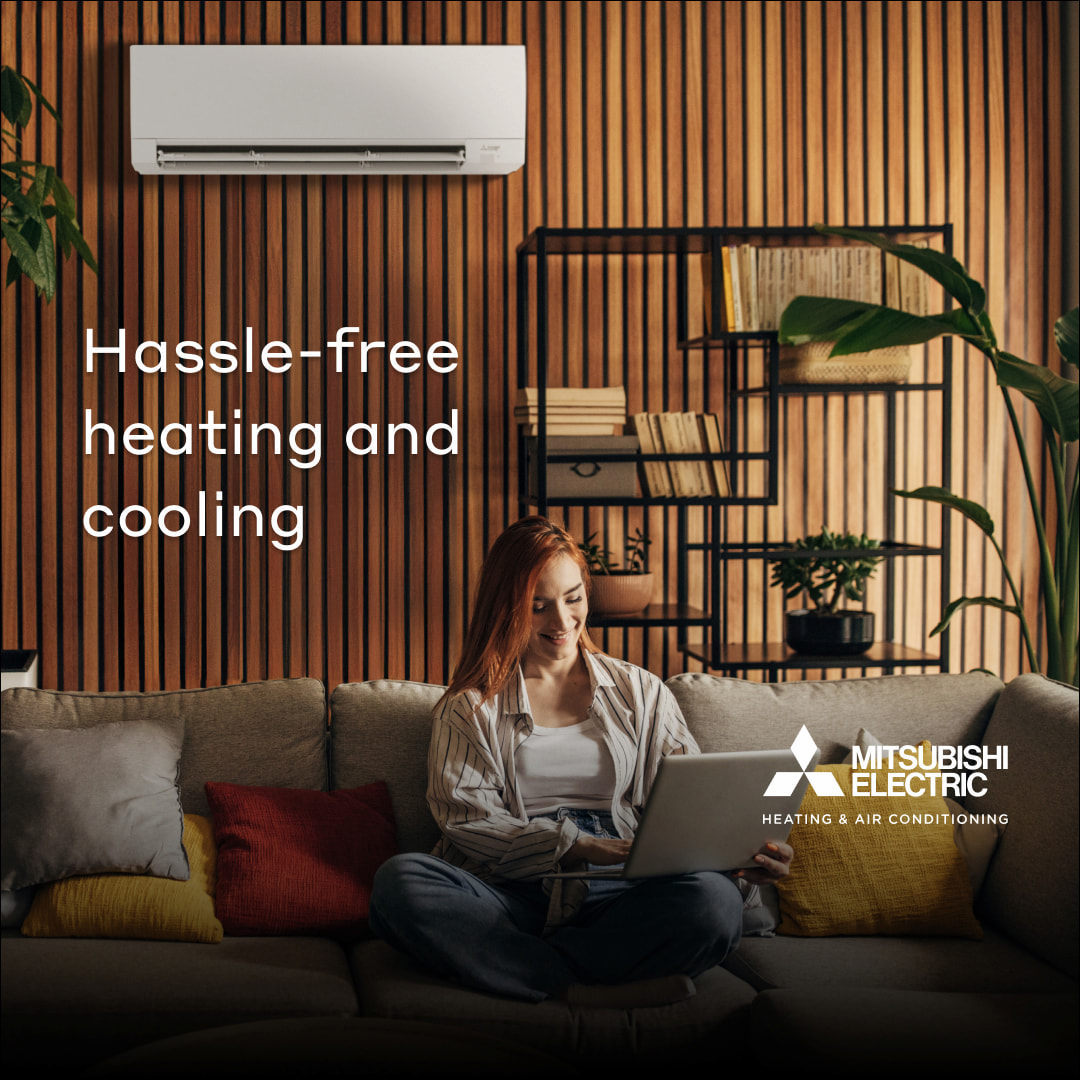 Woman on couch with ductless mini split on the wall