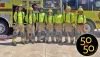 A group of Fire Academy students lined up in front of a fire truck