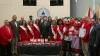 The commissioners, Strawberry Festival Court and staff standing in the BOCC boardroom with a table of strawberries and strawberry baked goods