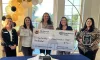 The 2025 Neighborhood of the Year recipient accepts a check from Hillsborough County Neighborhood Relations.