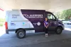 A woman leans up against the  Alzheimer's Association Brain Bus