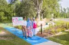 Members of 200 MWWC celebrate the opening of Branchton Park's new sensory sidewalk and pollinator garden.